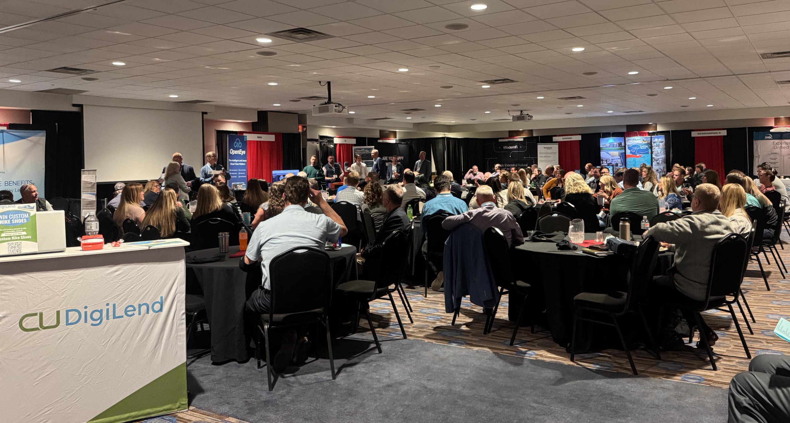 Photo of room filled with people in chairs during a presentation at the Montana Credit Union League Conference