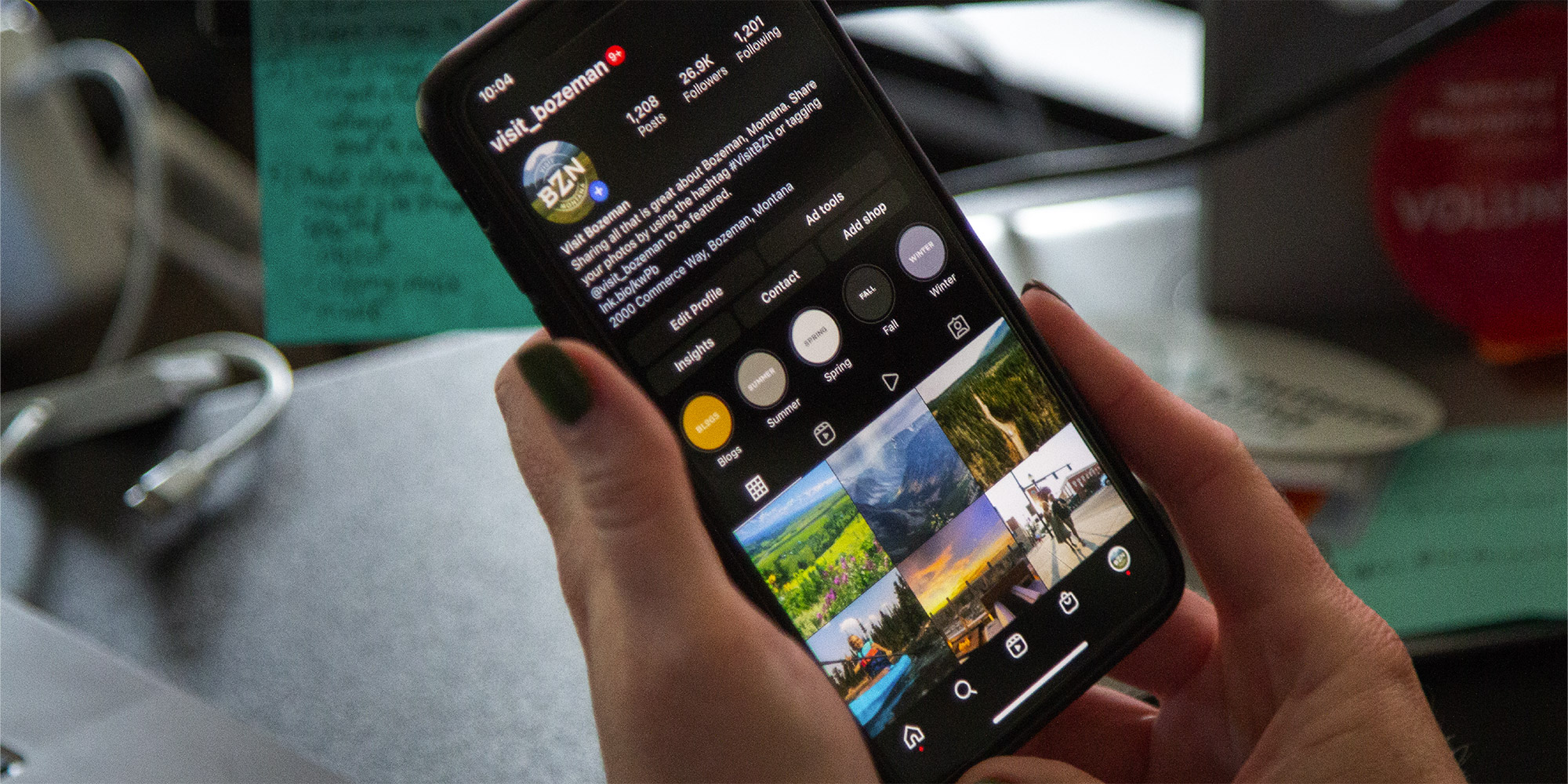 Photo of a person looking at an Instagram profile on their mobile device.